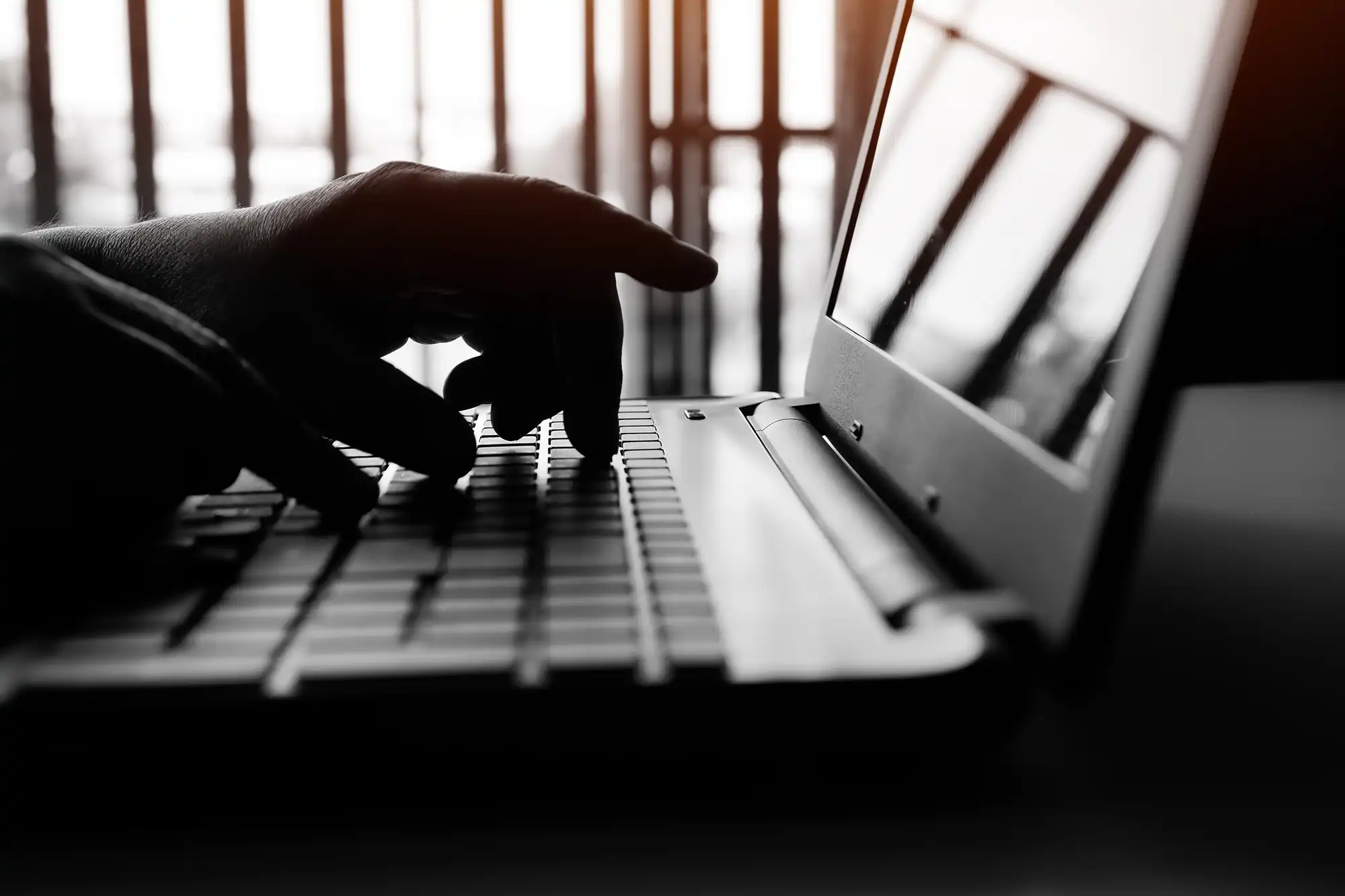 hands typing on a laptop